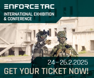 Two armed personnel in tactical gear at Enforce Tac 2025 exhibition banner